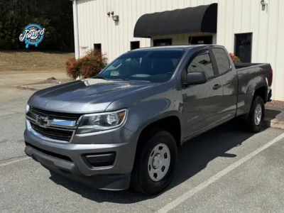 A technician using a rotary polisher to perform a professional paint correction.