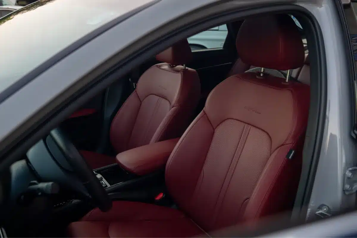Detailed car interior with clean leather seats and polished surfaces.